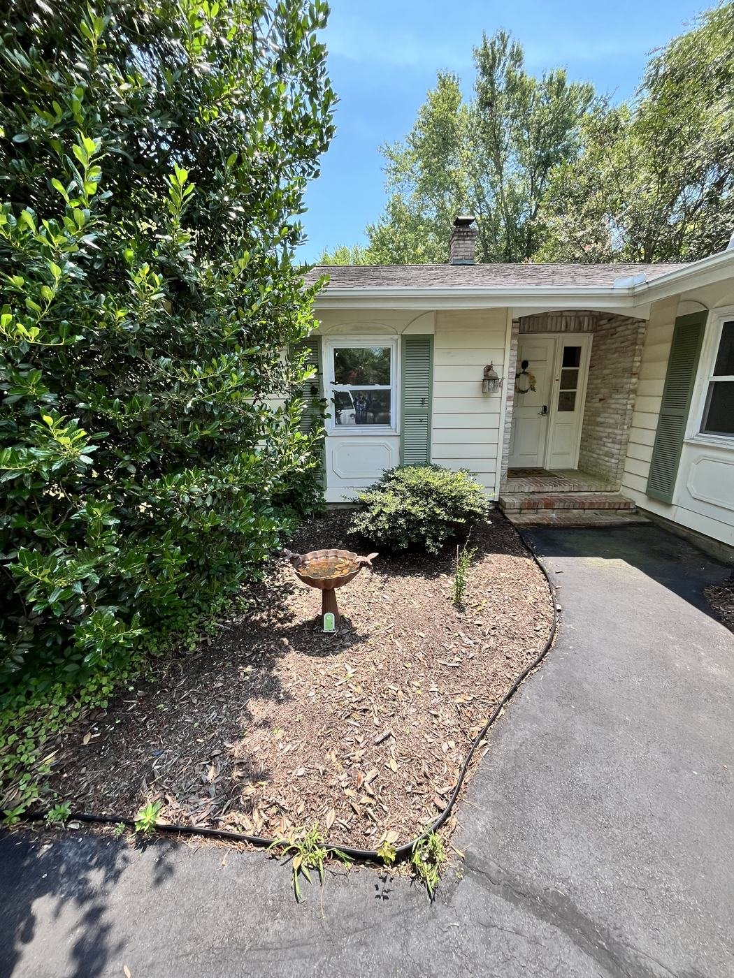 After — weeded and mulched entryway garden bed