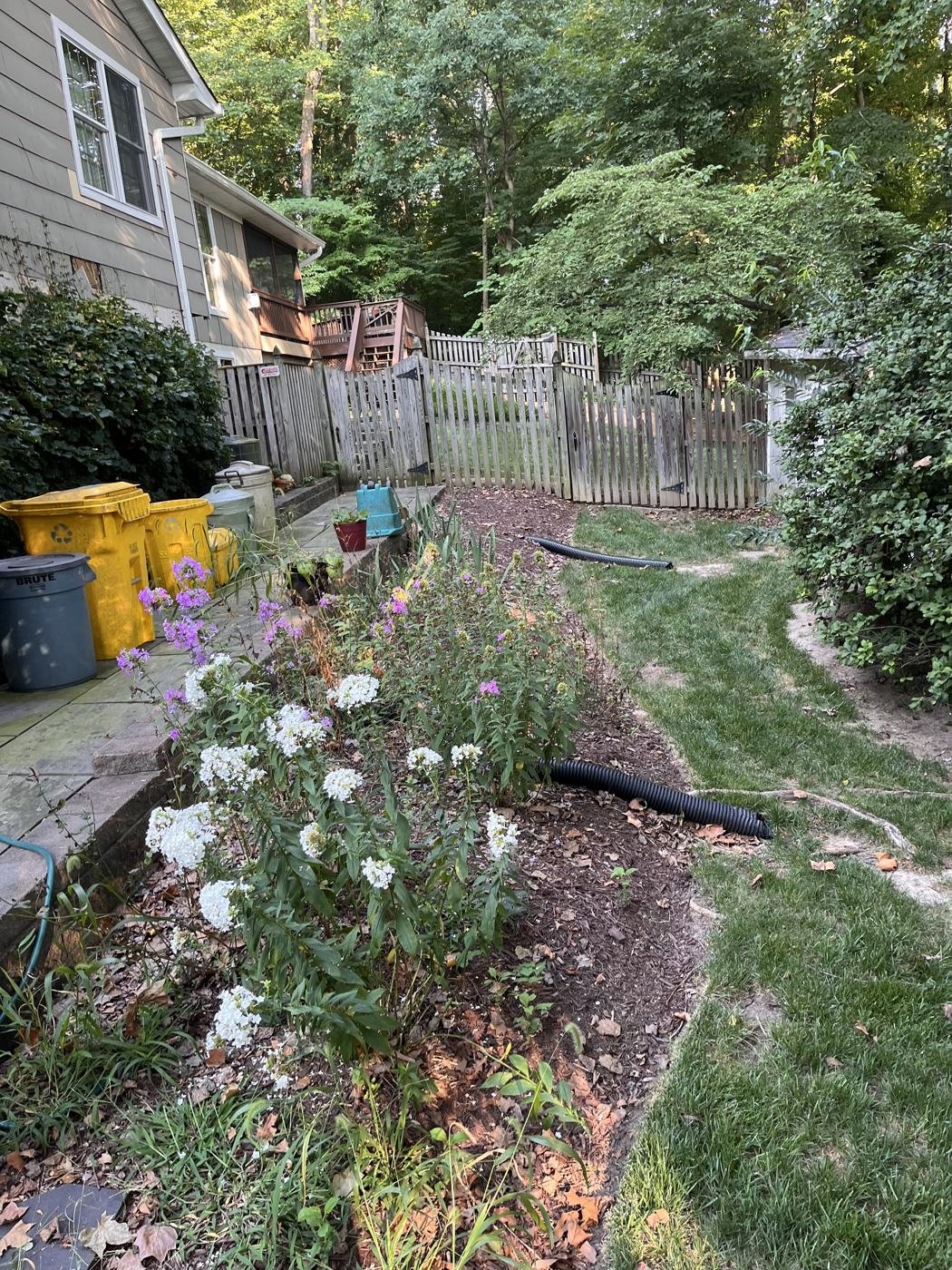 Before — backyard garden bed along the deck